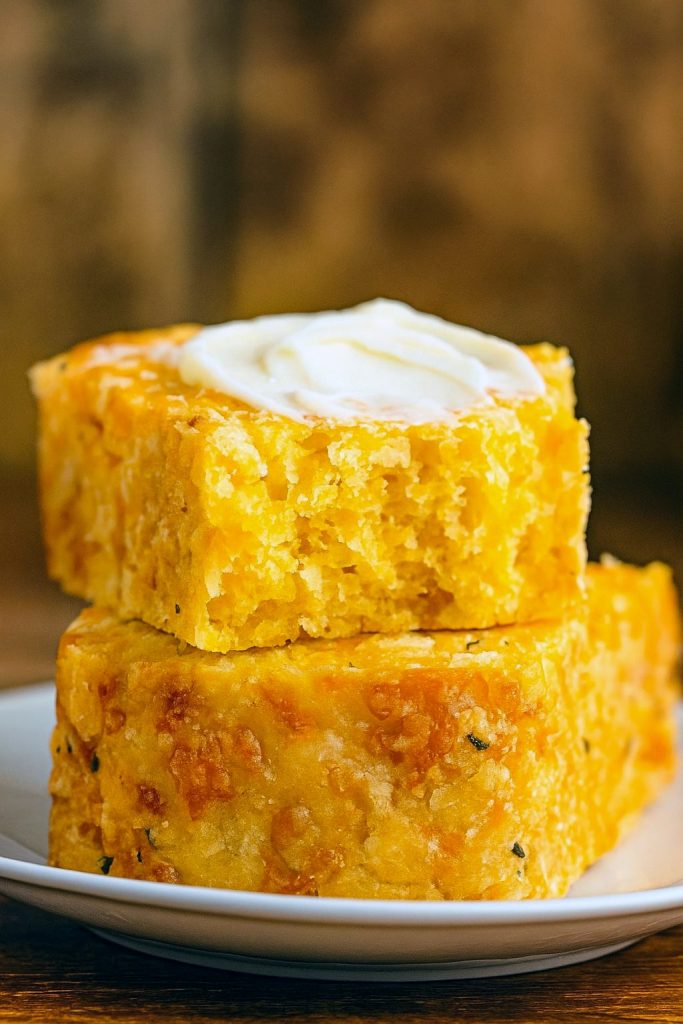 Close-up of a golden loaf studded with melted cheddar, highlighting the Easy Cheese Bread Loaf and showing the richness of this Easy Bread Loaf inspired by Retro Recipes 1970s; perfect visual for Easter Quick Bread Recipes and Savoury Bread Recipes, capturing the essence of Cheese Bread Baking Instructions, Cheddar Cheese Quick Bread Recipe, Cheddar Cheese Bread Machine Recipes, and that beloved Cheddar Bay Biscuit Cheese Bread flavor.