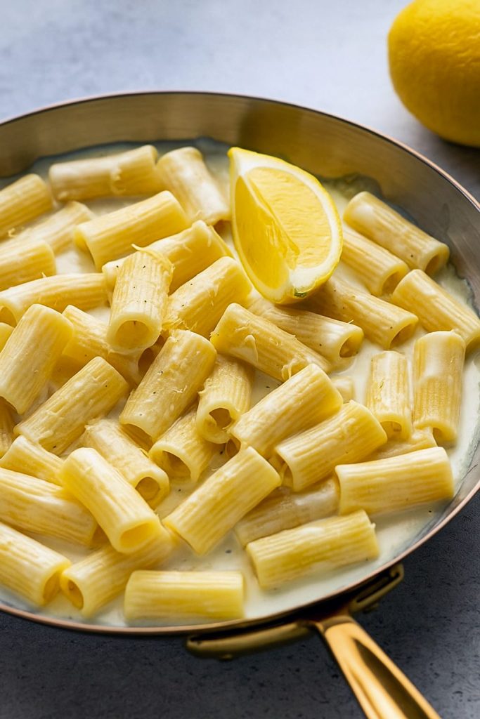 Bowl of creamy lemon pasta garnished with parmesan and parsley — a sunny Yellow Recipe shot that pairs with my Lemon Paste Recipe ideas and shows simple Lemon Paste Uses for extra citrus punch.