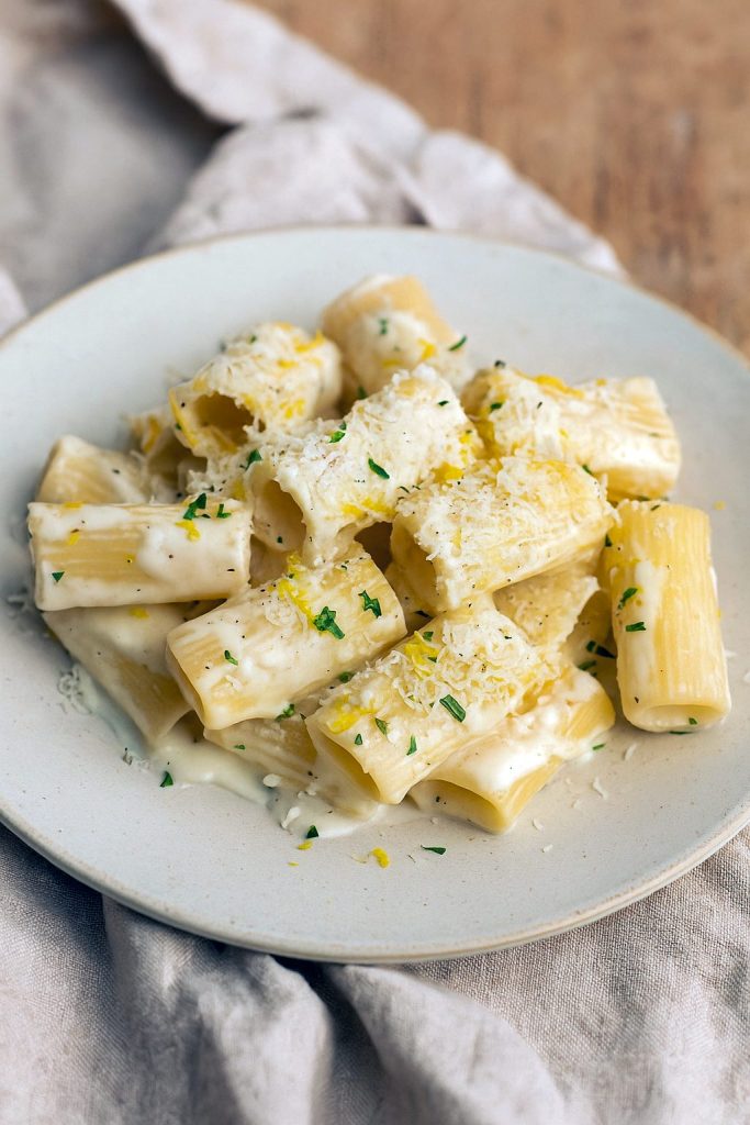 Bowl of creamy lemon pasta garnished with parmesan and parsley — a sunny Yellow Recipe shot that pairs with my Lemon Paste Recipe ideas and shows simple Lemon Paste Uses for extra citrus punch.