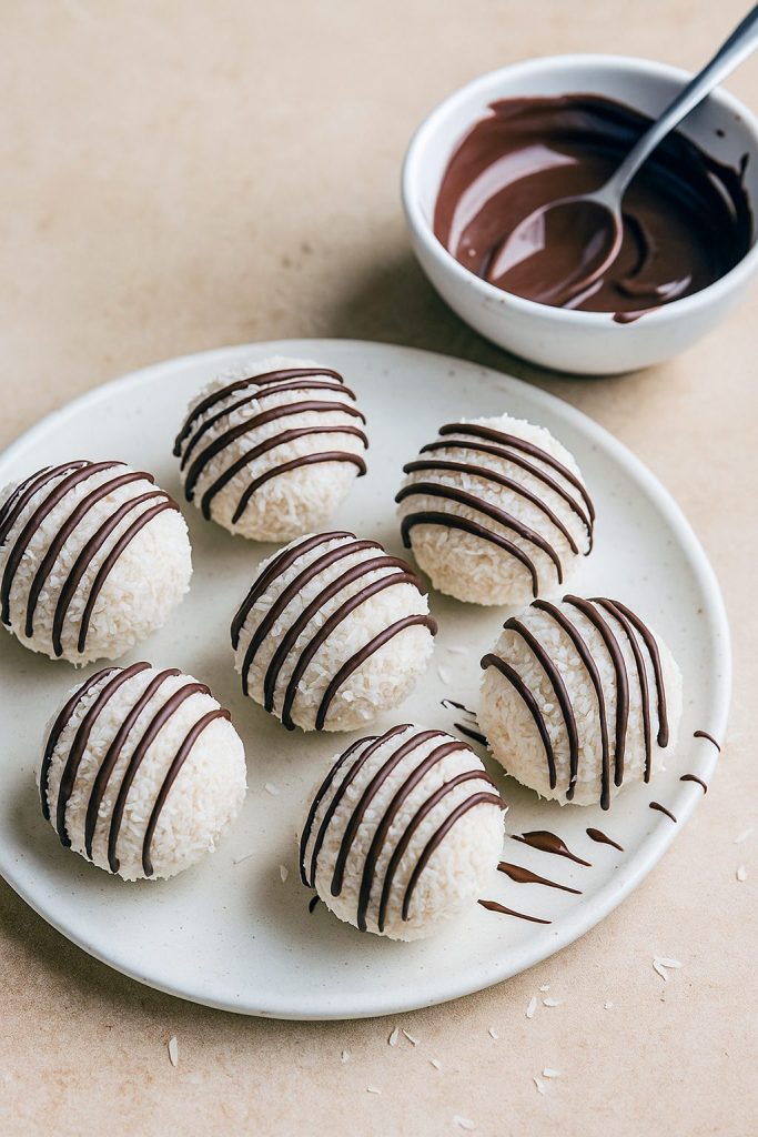 Round Chocolate And Coconut Balls with a glossy chocolate drizzle, arranged on parchment—perfect as Quick Coconut Desserts, party Easy Candies, or elegant Confectionery Recipes like Dark Chocolate Coconut Truffles with a Chocolate Truffles With Coconut Coating look.