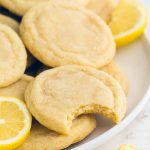 Stack of lemon cookies on a white plate with crinkled tops and golden edges, showing the texture of soft lemon sugar cookies and sparkle of lemon sugar, perfect for any cookie monster craving chewy lemon sugar cookies or quick lemon crinkle cookies from cake mix easy style treats.