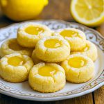 Close-up of Lemon Curd Thumbprint Cookies showing a glossy dollop of curd in each indent, featured in our Cookie Recipes Thumbprint collection for the ultimate Lemon Curd Thumbprint Cookies Recipe.