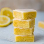 Close-up of Lemon Blondie Brownies showing their gooey, Moist Lemon Brownies interior; a drizzle of glaze highlights the Fudgy Lemon Brownies texture and Tangy Lemon Brownies flavor—perfect inspiration for How To Make Lemon Brownies, Lemon Brownies, Lemon Bar Cookies, Lemon Bars Recipe, and other Lemon Dessert Recipes.