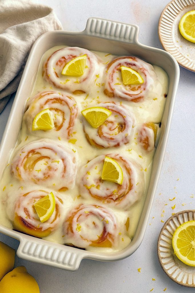 Soft lemon sweet rolls with glaze in a baking dish – a zesty alternative to Traditional Cinnamon Rolls, ideal as Homemade Breakfast Baked Goods, a Rolls Dessert, or a bright Lemon Cinnamon Rolls Recipe made with Dessert With Yeast for fans of Yeast Baked Goods and Sweet Roll Cake style treats. A deliciously fun Non Traditional Breakfast option and one of the best Lemon Snacks Healthy fans will love.