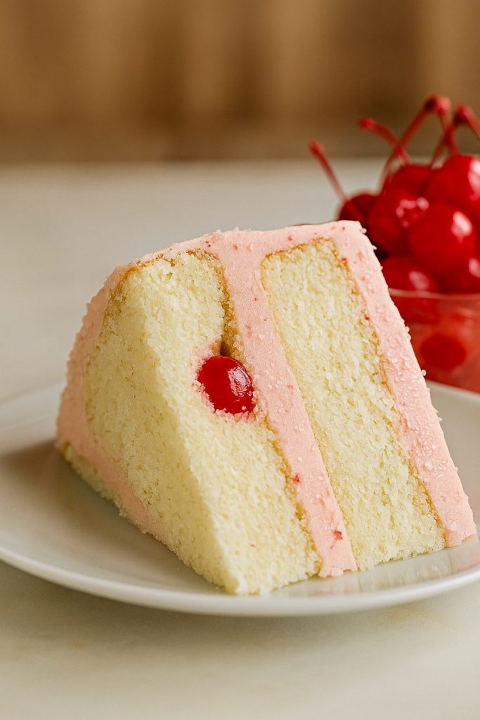 Moist Almond Cakes layered with creamy cherry frosting, topped with juicy cherries for a stunning Cherry And Almond Cake – the ultimate Just Desserts treat for holidays, parties, or everyday Sweets Treats indulgence.