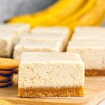 Close-up of three creamy cheesecake bars stacked on a white plate, revealing a golden crust and swirls of real banana filling—perfect for Banana Dessert Recipes, fans of Banana Cheesecake, or anyone craving a dreamy Banana Dessert.