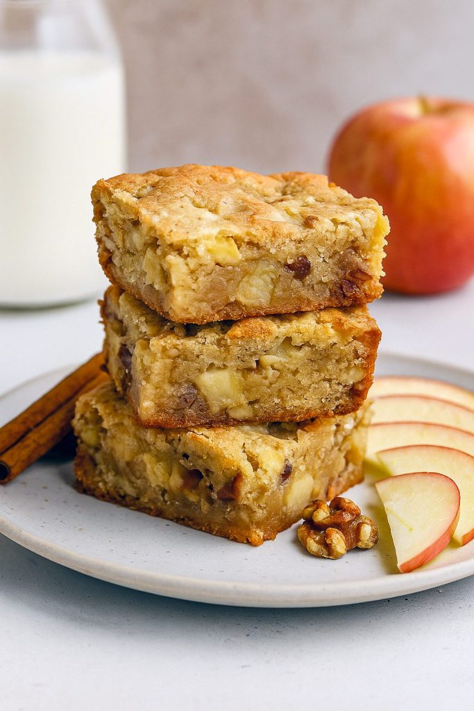A freshly sliced Best Apple Brownies bar studded with apple chunks and pecans, illustrating the ultimate Chocolate Apple Desserts, Apple Pecan Dessert, and Classic Thanksgiving Desserts vibe—this Apple Brownies Recipe doubles as Apple Pie Blondies, ideal Fall Dessert Bars, straight from your favorite Recipes Apples collection of Simple Apple Desserts.