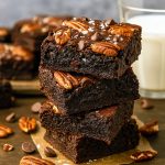 Close-up of fudgy Bourbon Brownies generously studded with toasted Pecan Brownies pieces and a glossy, crackled top.