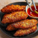 Close-up of crispy chicken strips coated in coconut and panko, perfect for Baked Coconut Chicken- Two Ways, showcasing an Idee Pasto Sano twist on classic Poultry Recipes.