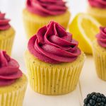 A golden Cupcake speckled with poppy seeds and crowned with deep purple blackberry buttercream—pure Yummy Food Dessert magic. This festive scene showcases one of the best Cupcake Recipes, a must-try for lovers of Just Desserts.